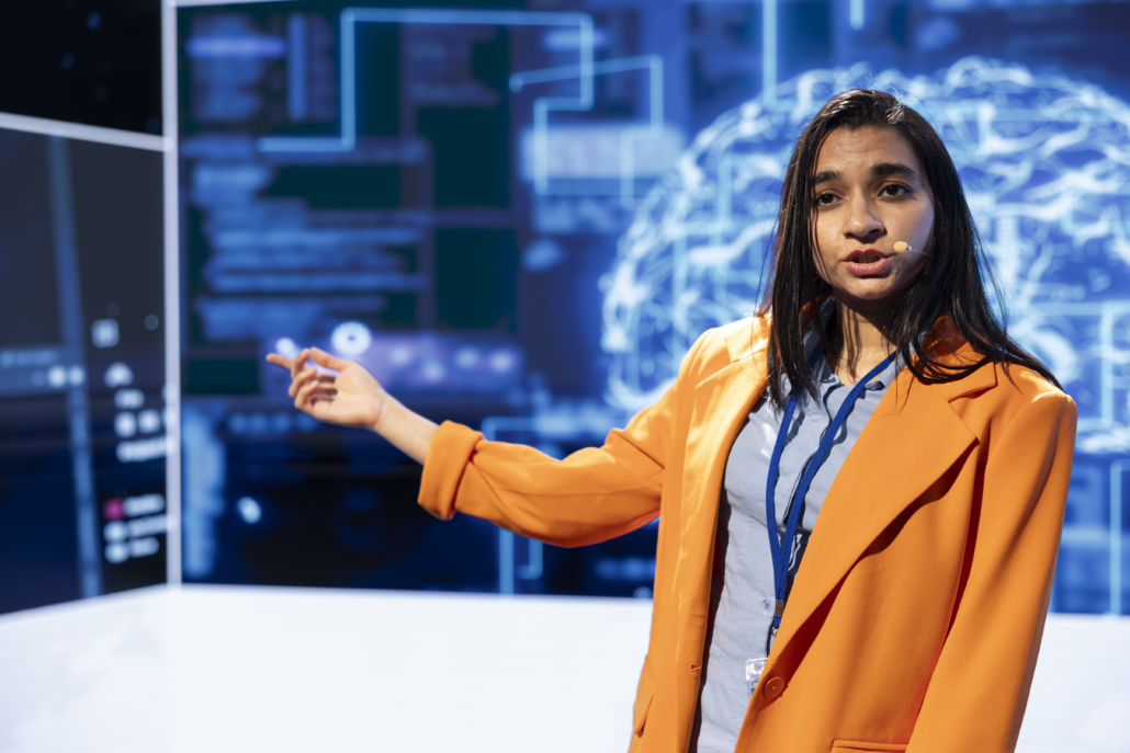 Speaker talking on stage in event bringing together leading AI specialists